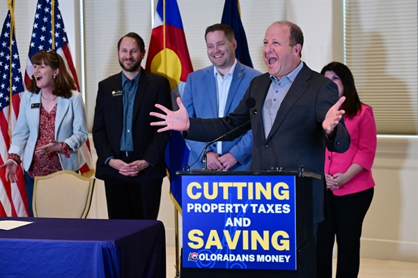 Gov. Polis signs cuts to income, sales and property taxes into law as ballot fight looms