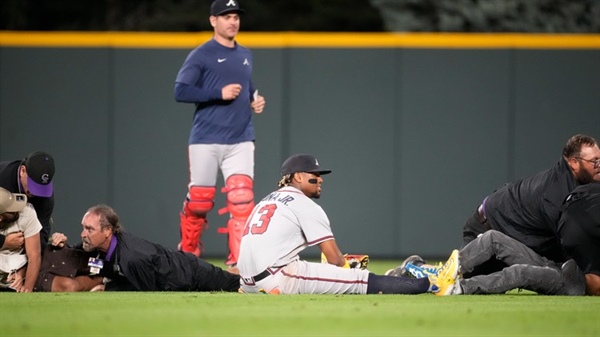 2 men accused of running onto Coors Field during Rockies-Braves game are...