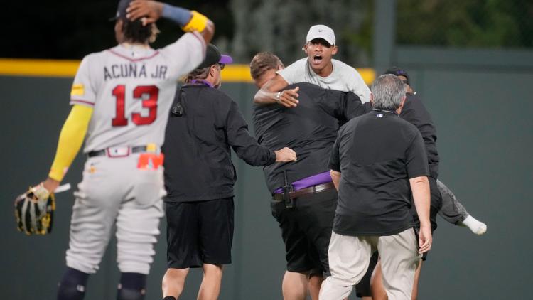 Ronald Acuña Jr. knocked over by fan charging field at Rockies game, but Braves...