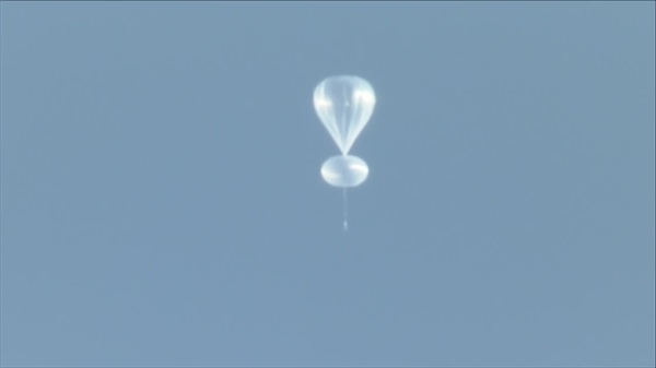 White jellyfish-like balloon over Denver measuring solar radiation for NASA