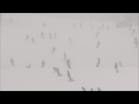 Joyful skiers enjoy opening day at Breckenridge during Colorado snowstorm