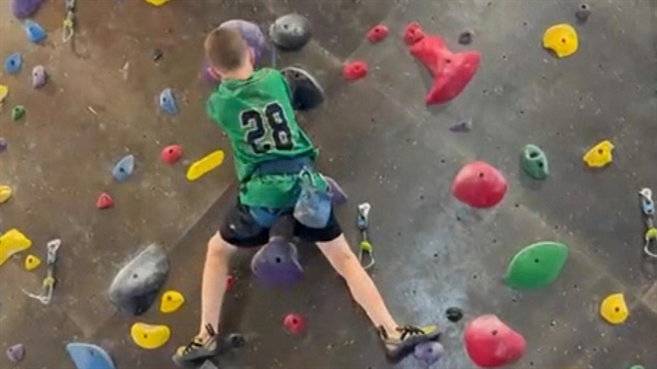 Young climber presents Make-A-Wish Colorado with huge check at his school assembly after climbing fundraiser